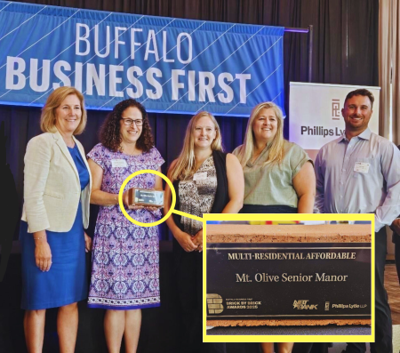 People Inc. Employees stand in group tp accept Buffalo Business First award for Mt. Olive Senior Manor