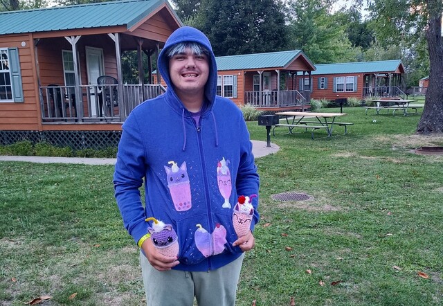 Laney poses with crochet creation