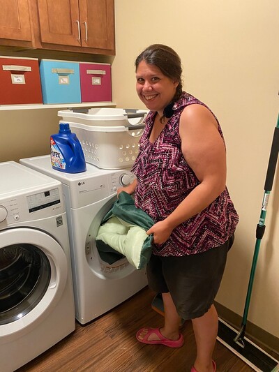 Resident doing laundry at On Our Way @Wayside