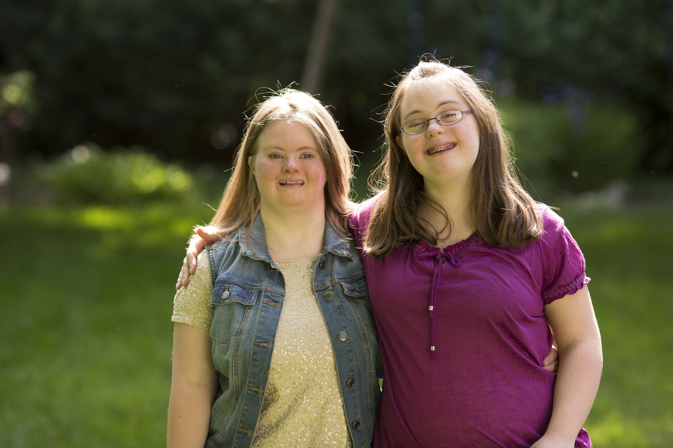 Shop Help ensure that people with developmental disabilities, special needs and older adults receive the supports they need. Two teen girls smiling in a yard.