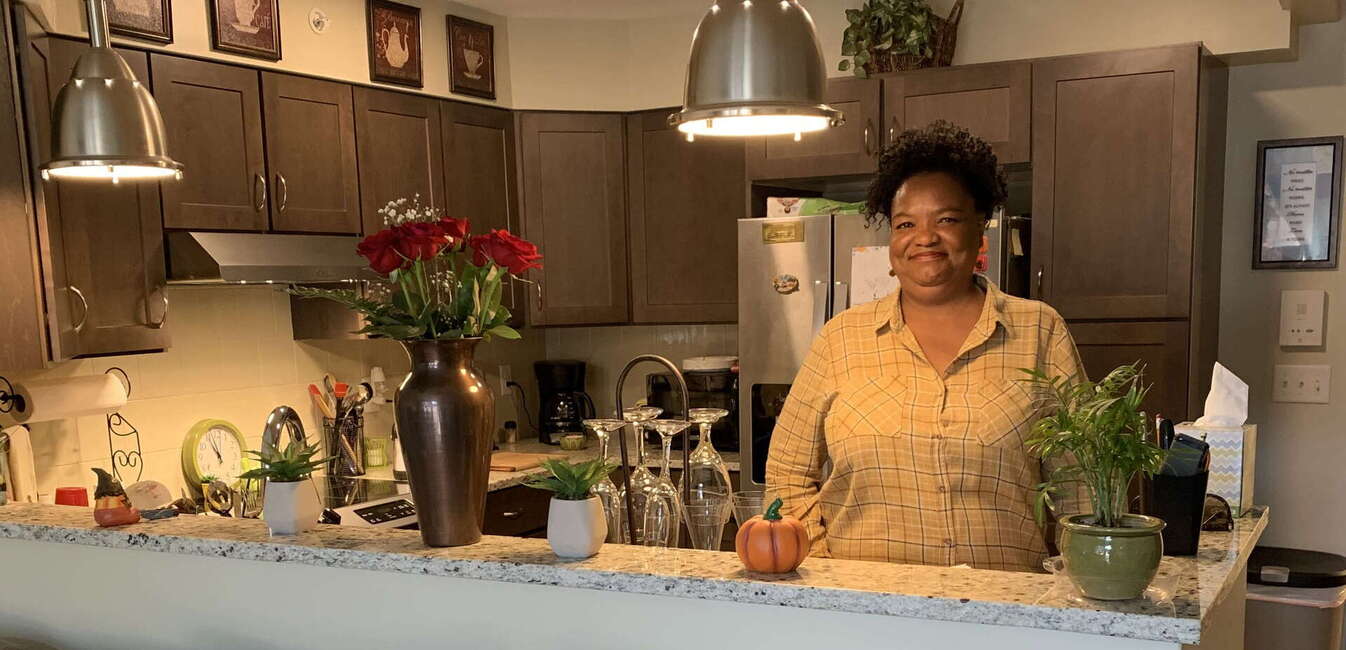 Smiling African American woman standing in decorated kitchen