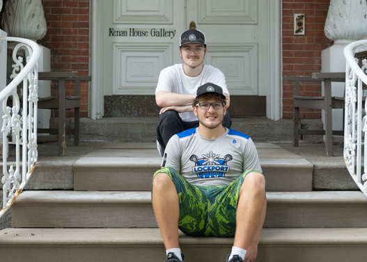 the pair pose for a photo on the stairs