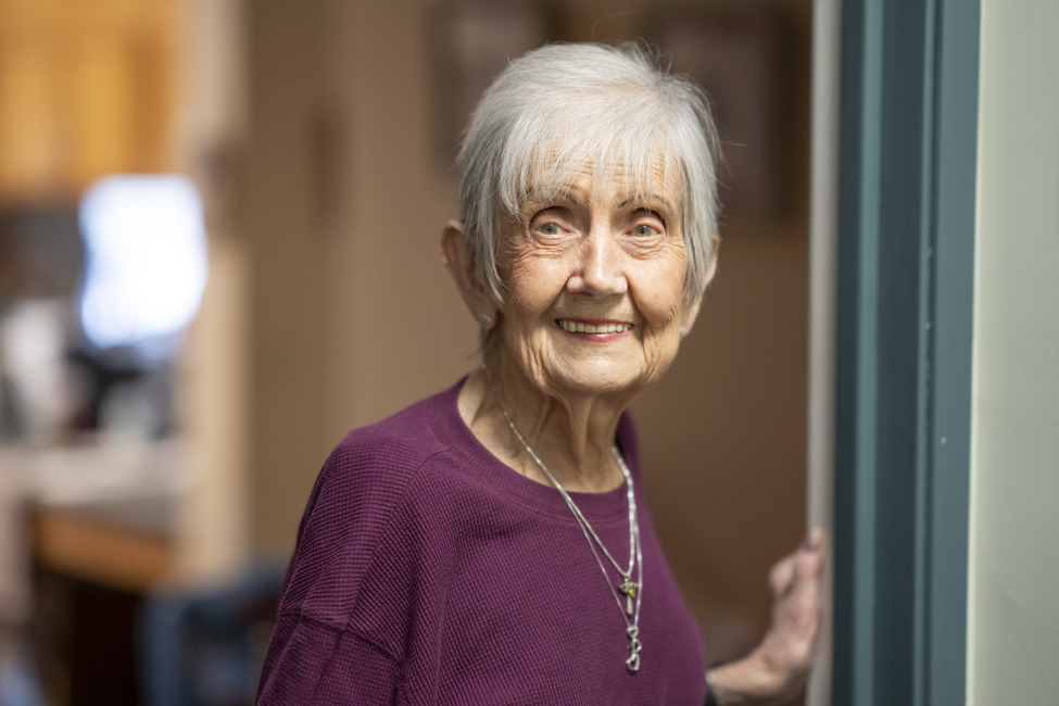 Senior woman smiling sitting in community room