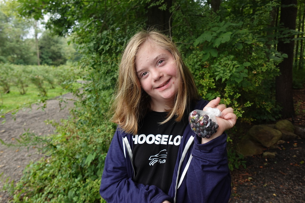 Showing off freshly picked blueberries at Blueberry Treehouse Farm