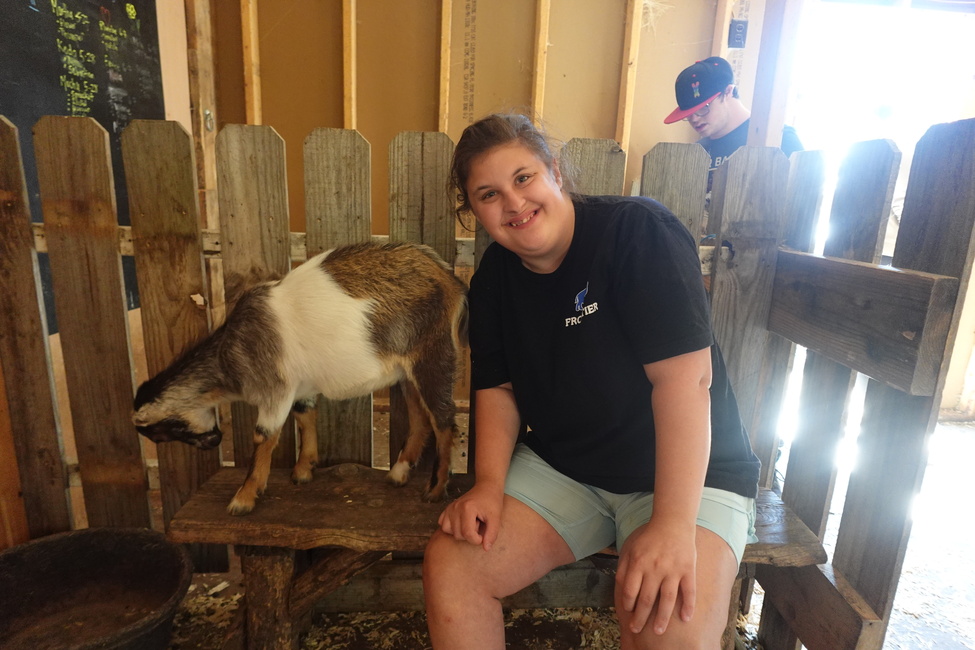 Interacting with a therapy goat at Rowandale Goat Farm