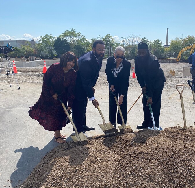 Four people participate in the groundbreaking at Mt. Olive Senior Manor - the Gillison family and John Baker, artist.