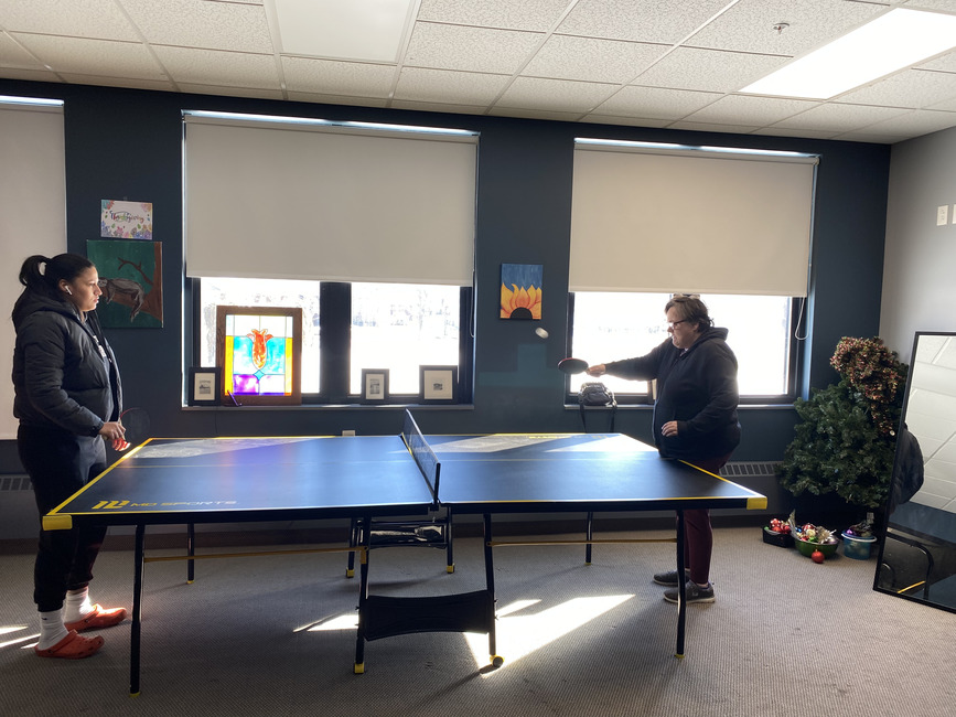 Two people playing ping pong