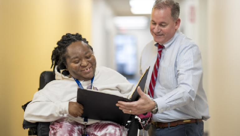 Shanell Davis and David Squires, VP Learning & Development, review an upcoming training presentation.