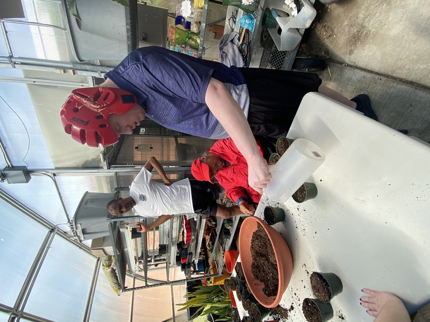 Watering the newly planted seeds.