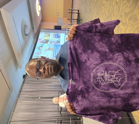 Brandon Scott displays his winning logo design.