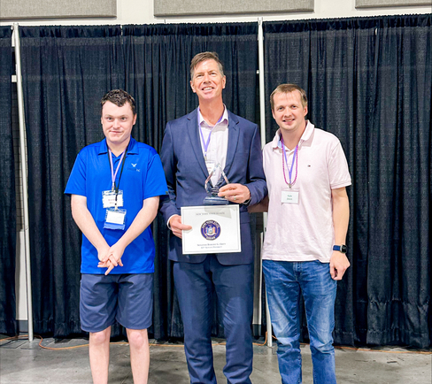 Dr. Dennis Garland with Special Olympic athletes Brandon and Kyle.